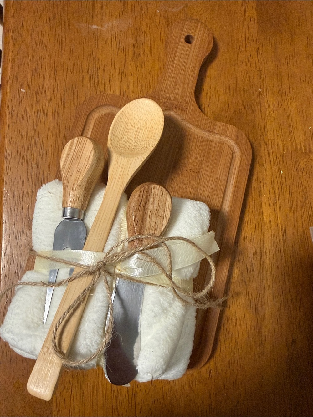 Rustic Bamboo Paddle Board with Wooden Utensils and Cream Napkin